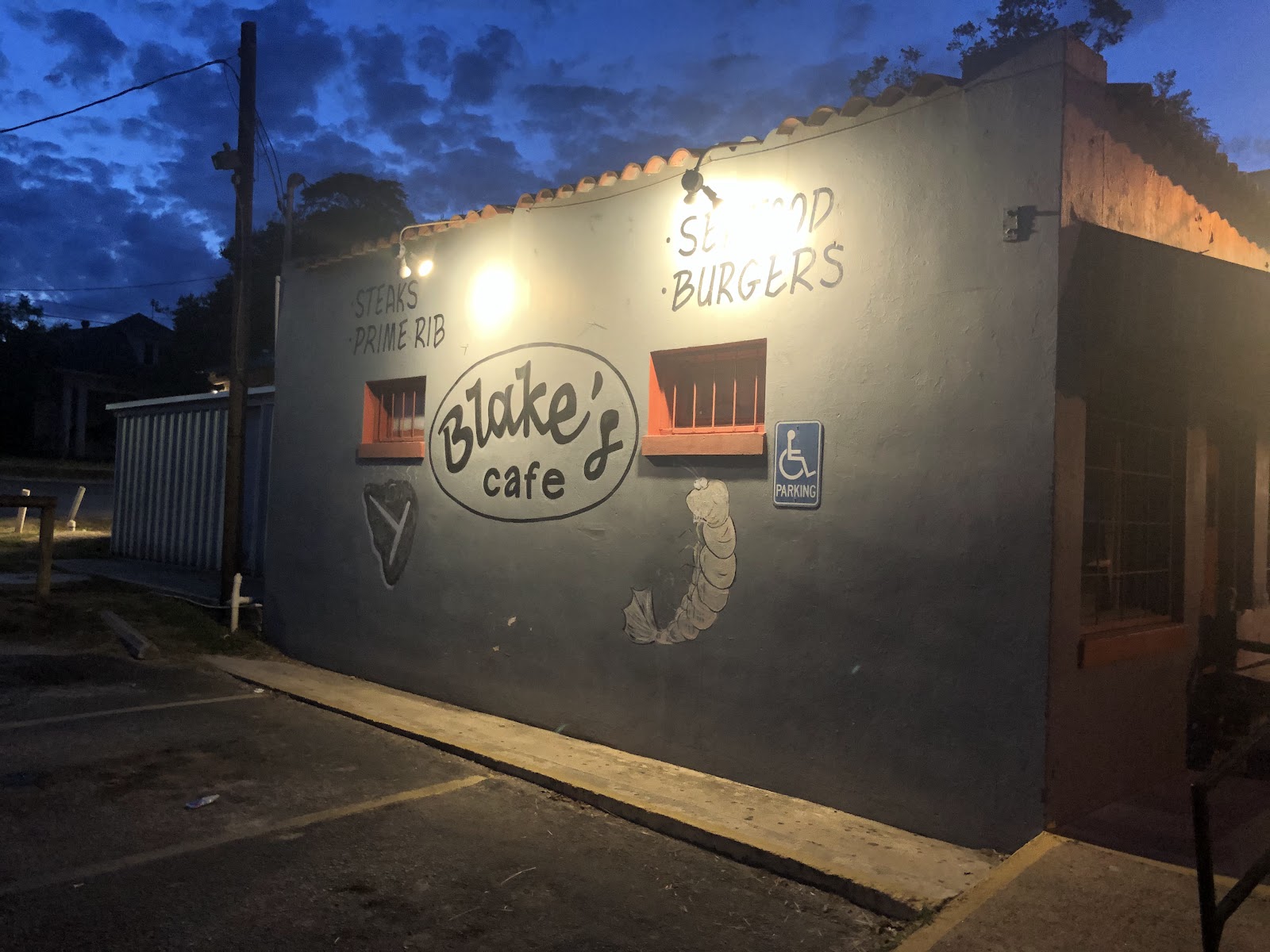 Blake's Cafe exterior sign at dusk reading Steaks, Prime Rib, Seafood, Burgers