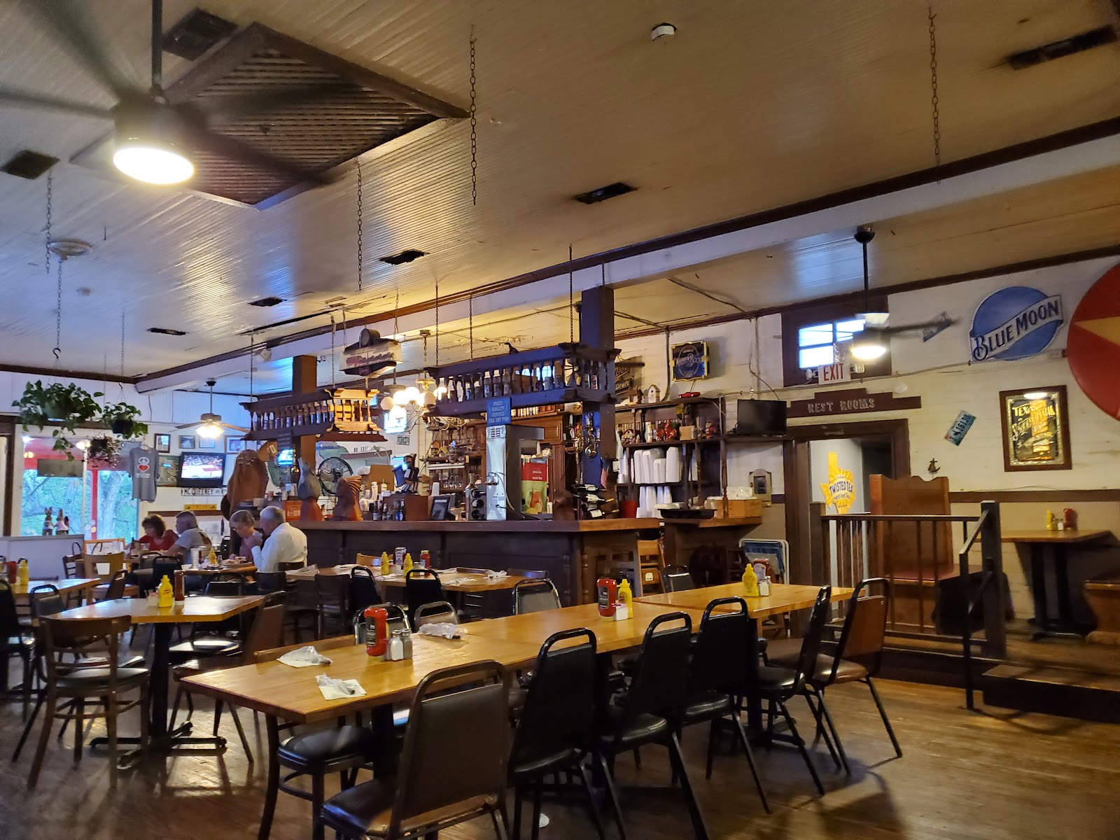 Cozy dining room interior at Blake's Cafe with wooden tables and a well-stocked bar