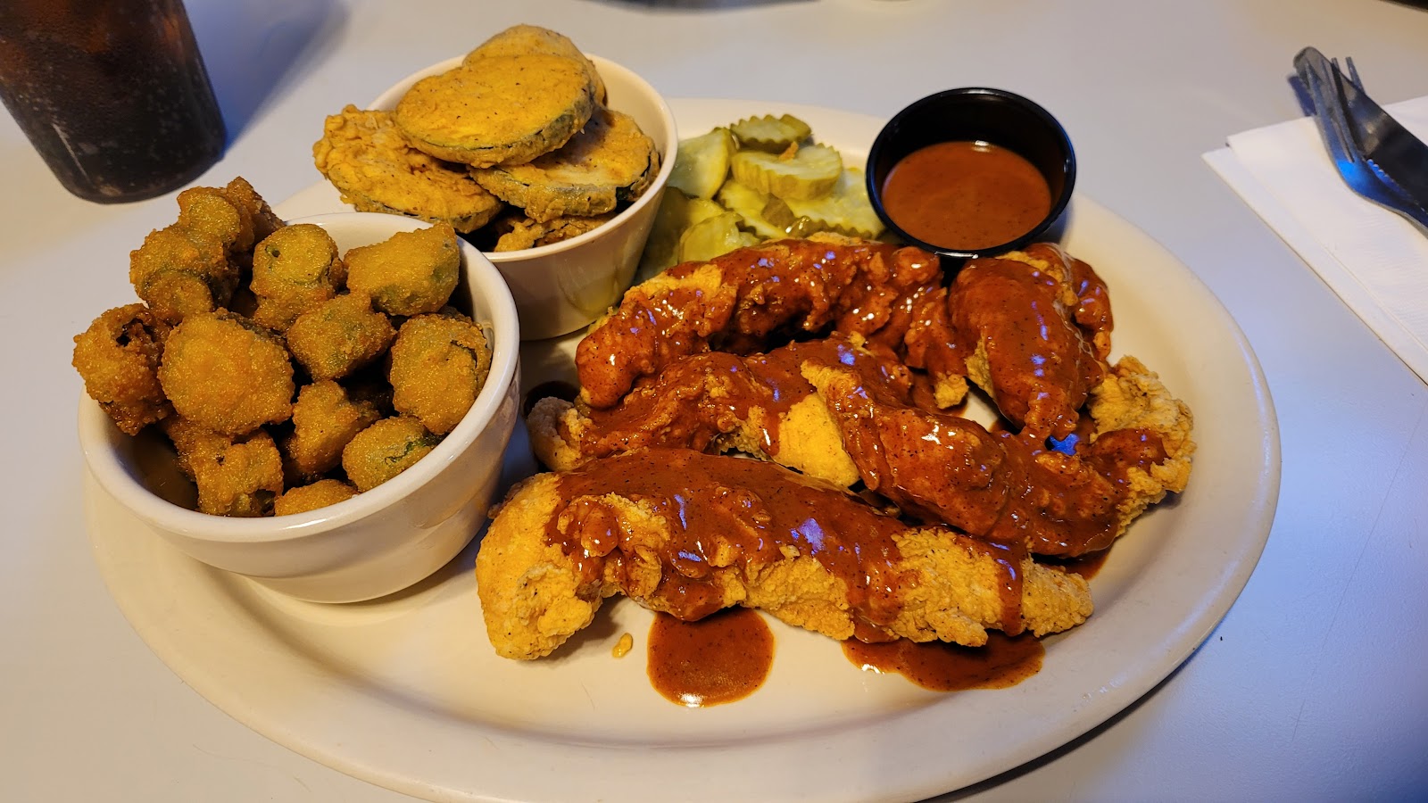 Crispy fried chicken tenders with fried pickles and fried okra
