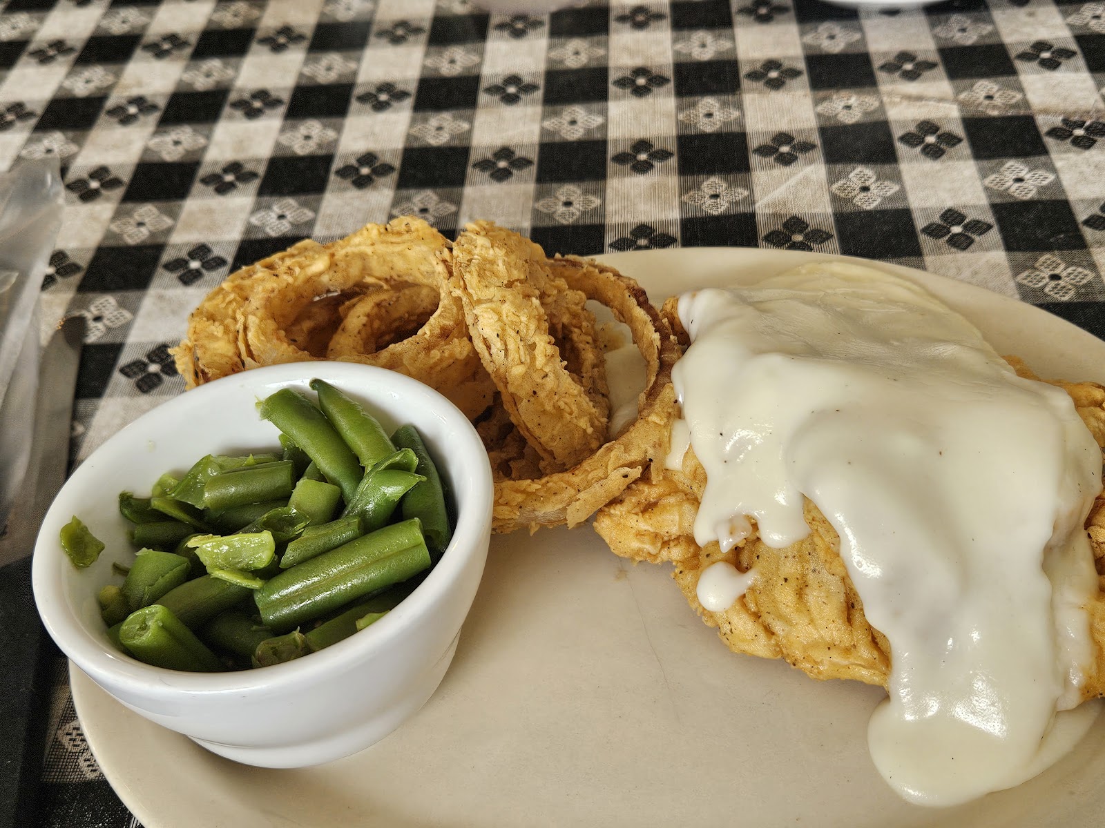 Chicken fried steak with onion rings and green beans